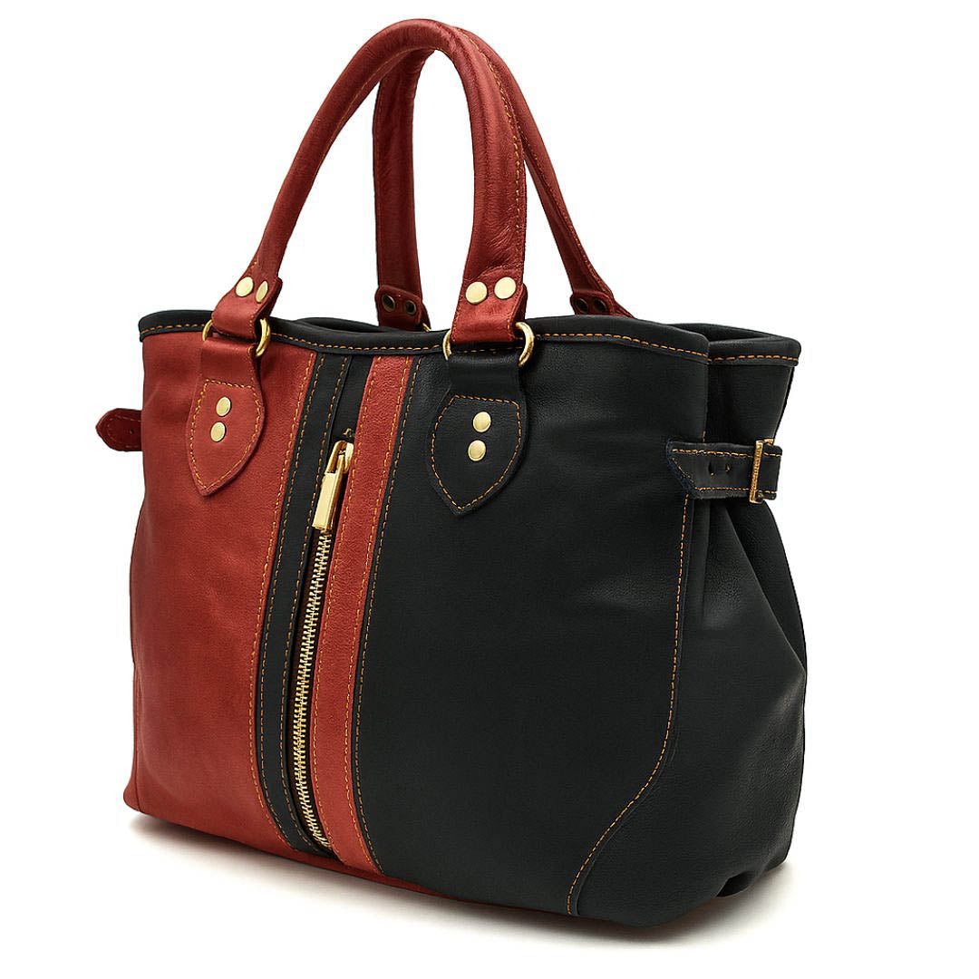Two-toned red and black handbag with gold accents on a white background